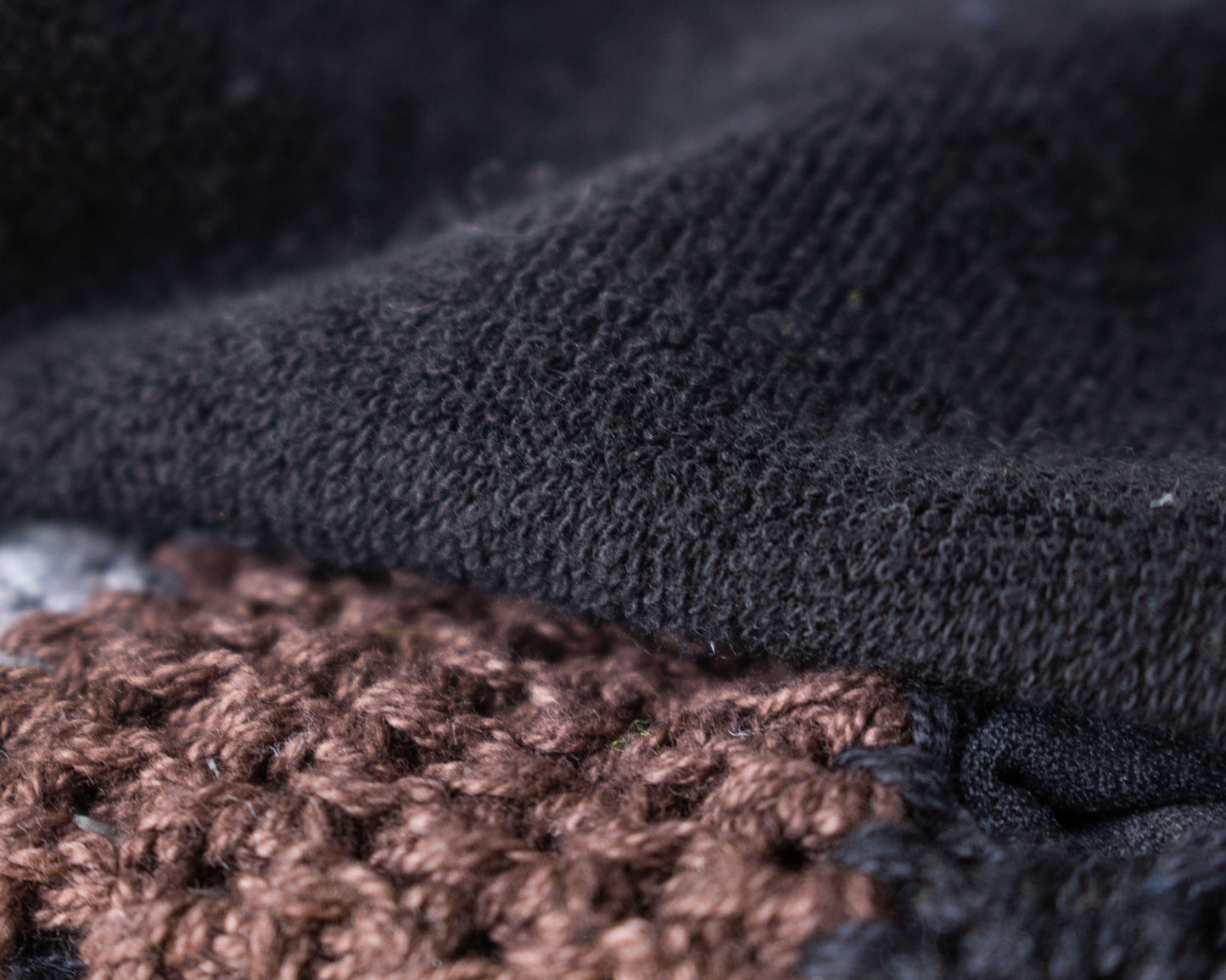 Padded, breathable mountain biking gloves made with goat leather and knitted yarn. Close up of upper material and thumb nose wipe