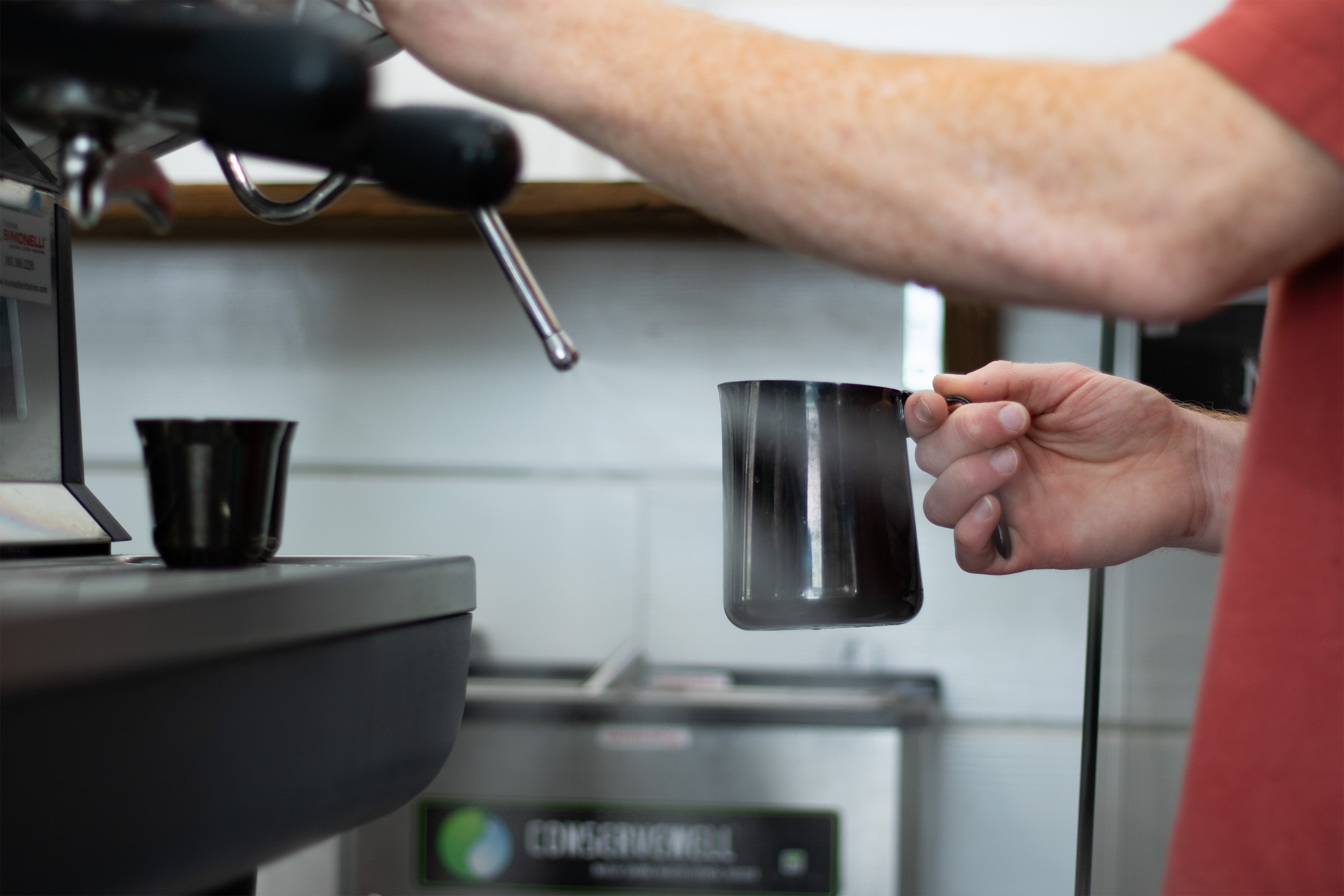 Barista purging espresso machine steam wand