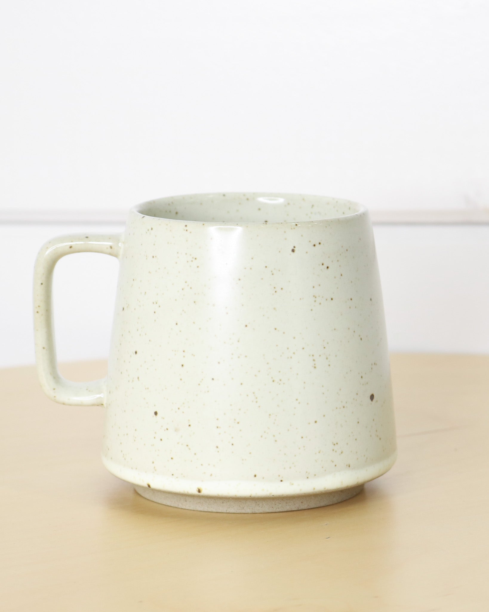 Brown Speckled White Ceramic Mug With Handle and Biking Bison Logo, Back