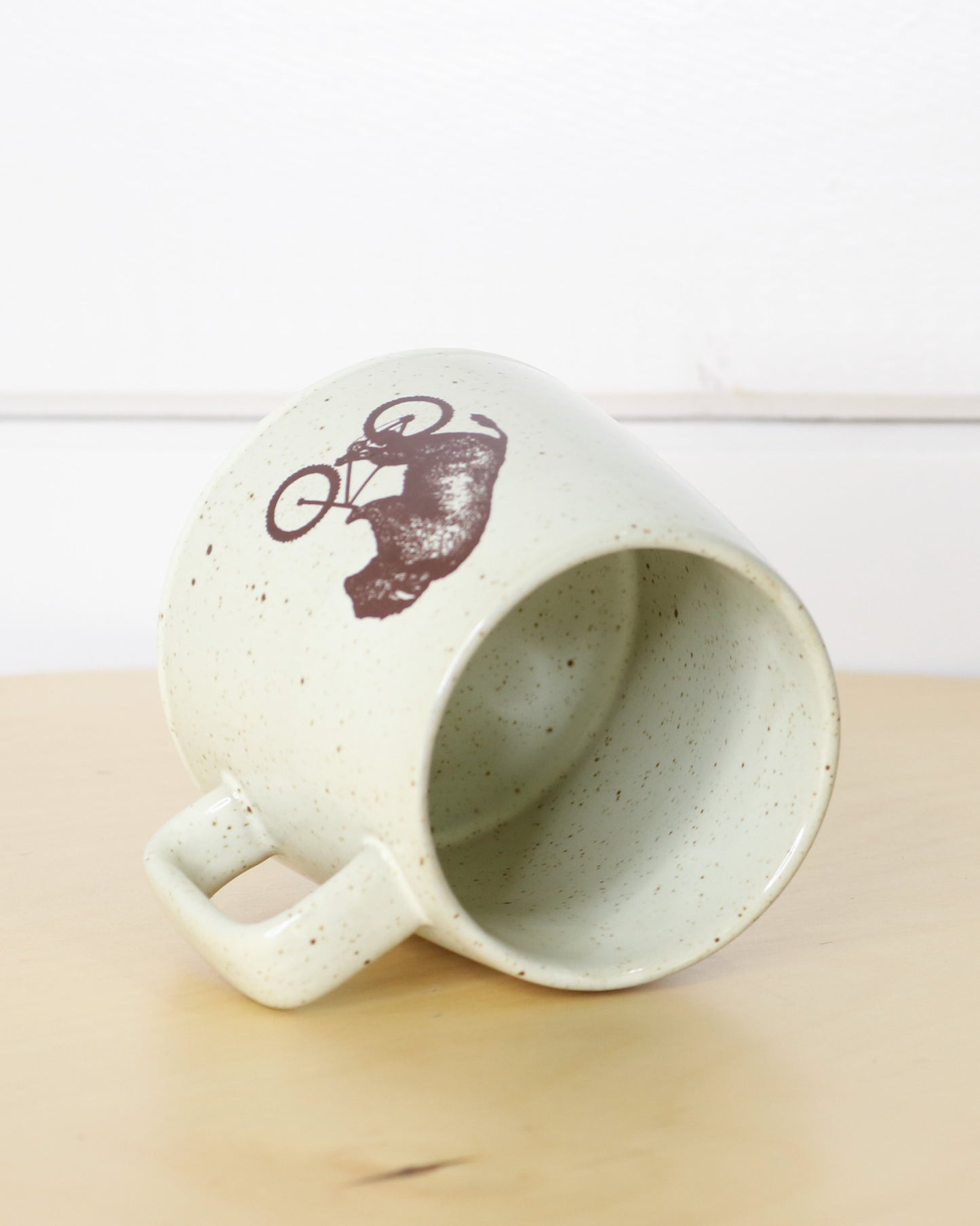 Brown Speckled White Ceramic Mug With Handle and Biking Bison Logo, Side
