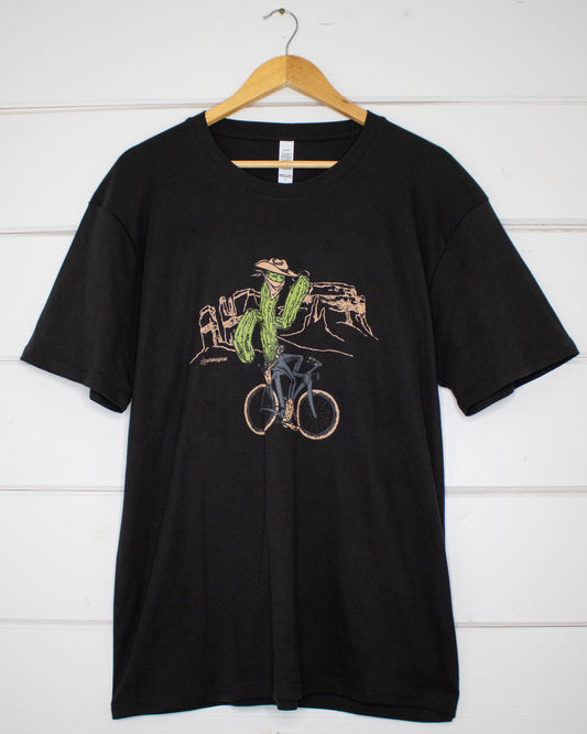 Black unisex t-shirt with bicycle riding cactus illustration on front